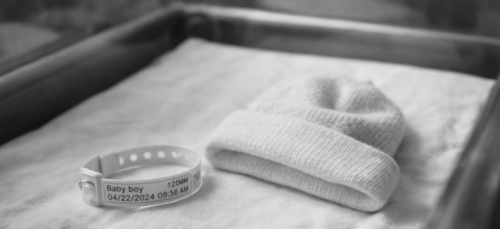 Black and white hospital bassinet representing surrogacy in Canada